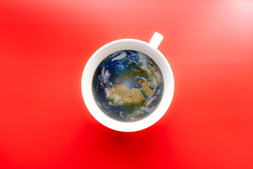 A cup of coffee with a shape of World. Red background