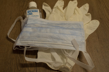 Fototapeta na wymiar Coronavirus prevention medical surgical mask and gloves with sanitigel hands gel for coronavirus covid-19 protection