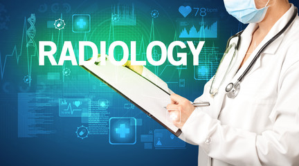 young doctor writing down notes with RADIOLOGY inscription, healthcare concept