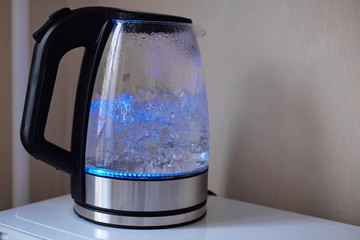 Electric transparent kettle with lighting, with boiling water