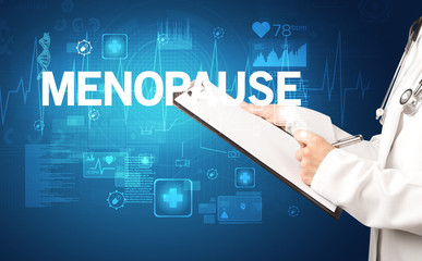 young doctor writing down notes with MENOPAUSE inscription, healthcare concept