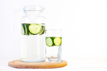 Health care, fitness, healthy eating concept. Fresh cool.cucumber drink with water, cocktail, detox drink, lemonade in a glass jug and a glass.