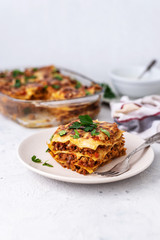 Delicious homemade italian Lasagna with bachamel sauce on gray background. Hot tasty Lasagna with cheese