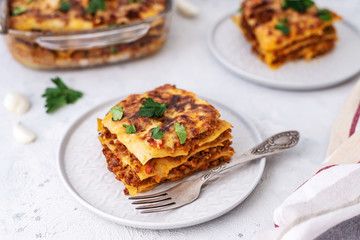 Delicious homemade italian Lasagna with bachamel sauce on gray background. Hot tasty Lasagna with cheese