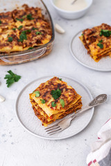 Delicious homemade italian Lasagna with bachamel sauce on gray background. Hot tasty Lasagna with cheese