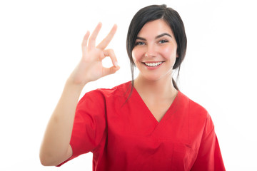 Portrait of young attractive female nurse making ok gesture