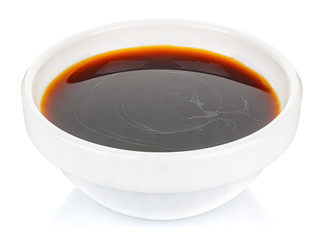 Soy sauce in a small white ceramic round bowl isolated on white background