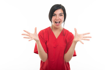 Portrait of young attractive female nurse making happy gesture