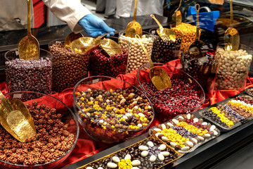 Chocolate truffles, candies and sweets store on showcase in factory store. Chocolate bit sized for...
