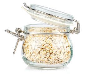 Dry rolled oats in a open transparent glass jar with rubber seal and metal clamp on lid isolated on white background