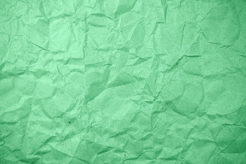 Green crumpled paper texture as background