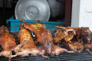 Guinea pigs being barbecued on Ambato Street at the market hall in Banos, Ecuador. In Ecuador, guinea pig (cuy) is considered a delicacy