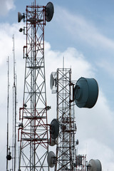 Group of modern antennas with flat parabola in Quito near by mountain.