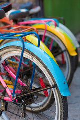 Obraz premium Various colored bikes standing in a row in the historic center of Guatape, Colombia.