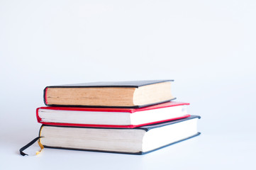 Open book. Open notebook. A stack of books. On a white background.