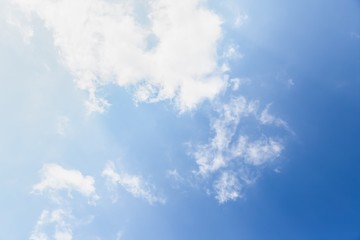 Fototapeta na wymiar Light transparent white light clouds on a blue background