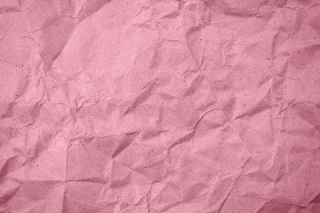 Fototapeta premium Crumpled pink paper in the background