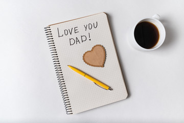 Notice I love dad in Notepad on a white background. Words handwritten. father's day