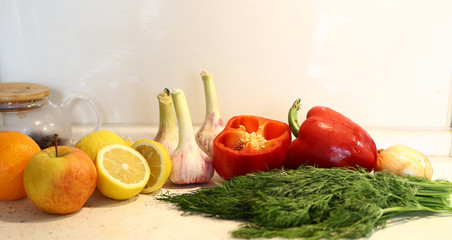 appetizing lentil porridge 
in a white dish, healthy eating background of various fruits and vegetables on a light kitchen countertop. Vegetarians. Lean food