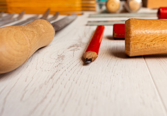 ordered carpenter tools on white wooden board