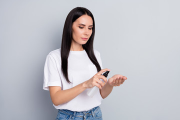 Portrait of her she nice attractive lovely pretty healthy straight-haired girl using spray washing...