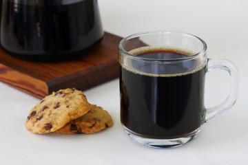 black coffee and chocolate chip cookies on the table