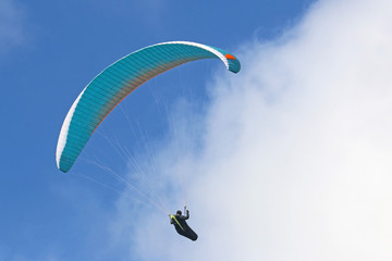 Paraglider flying wing in a blue sky	