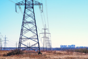 Towers with insulators on which the wires are fixed. High-voltage power transmission line. An extended structure of wires, cables and supports for the redistribution of electricity in the city.