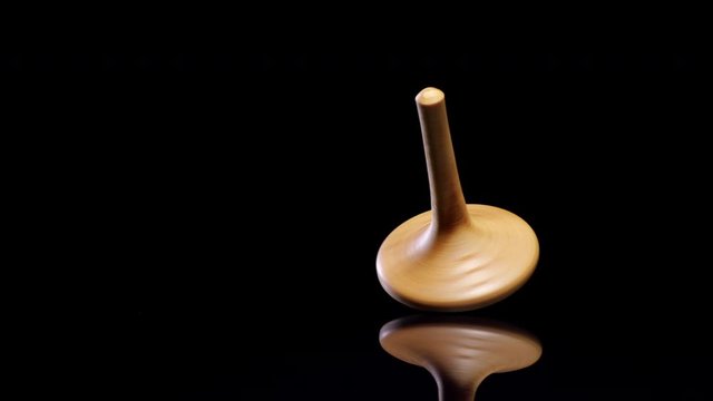 Wooden spinning top moving. Close up shot. 
