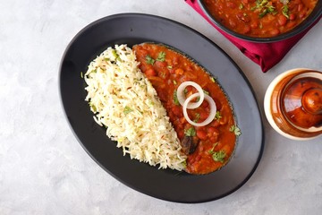 Rajma Chawal is a popular North Indian Food. Rajma is a socked Red kidney beans cooked with onions, tomatoes and a special blend of spices. Served with Jeera rice or Cumin Rice. With Copy Space.