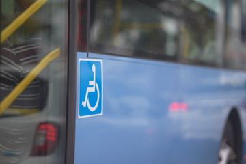 handicap sign on side of bus near door