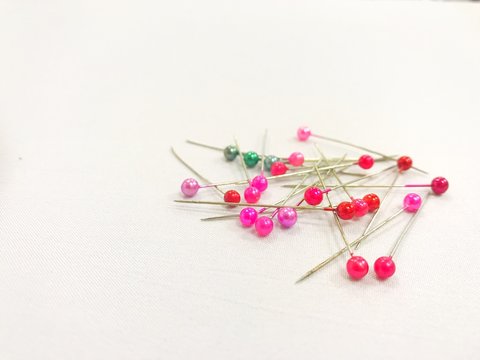 Close-up Of Colorful Straight Pins On Table