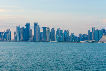 Naklejka premium View of modern skyscrapers and bay at twilight in Doha, Qatar