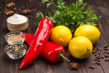Three lemons and two chili peppers, parsley, salt and spices.