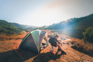 wanderlust and relax in nature with hiker man camping on top of mountain on spring and summer season