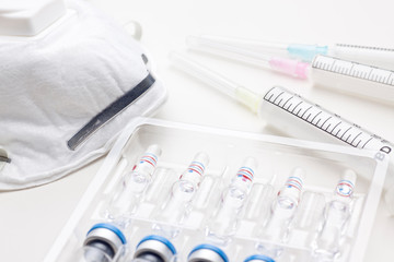 Medical ampoules, surgical mask and syringe for vaccination or beauty treatment