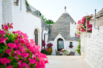 Trulli of Alberobello, Puglia, Italy: Typical houses built with dry stone walls and conical roofs. In a beautiful sunny day.