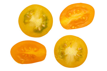 Fresh and raw yellow cherry tomatoes, cut in half. With water drops. Isolated on white background.