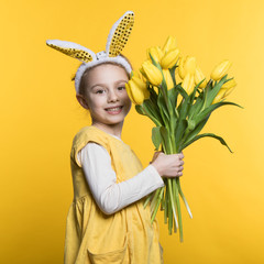 Smiling little girl with bunny ears with flowers