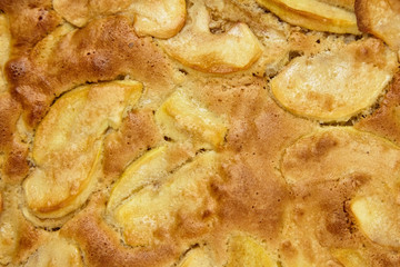 Apple pie, dessert from stewed fruits, closeup, texture, background, top view. Charlotte, homemade baking