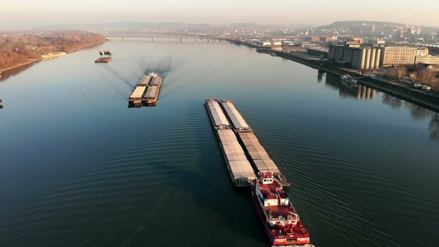 Tugboats pushing barges on the river, aerial view