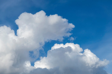 White clouds against blue sky on sunny day. Background image.