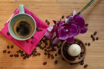 Espresso and coffee beans in background.