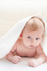 cute baby after bath in towel on a light background