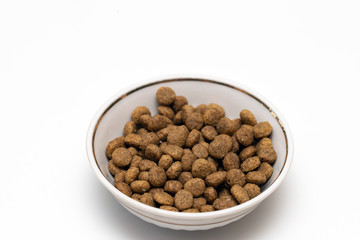 Balls of cat food in a beautiful bowl on a white background