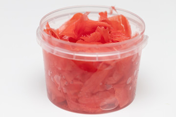 Pickled ginger in a jar isolated on a white background.