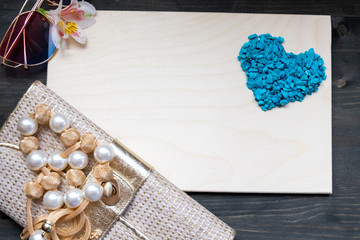Valentine's day frame composition with flowers. Blue hearts blank sheet of paper. Top view, flat lay, copy space.