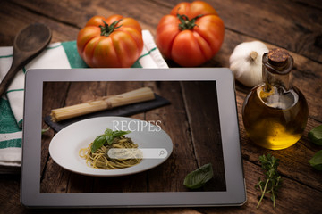 Food recipes tablet computer on rustic wooden table