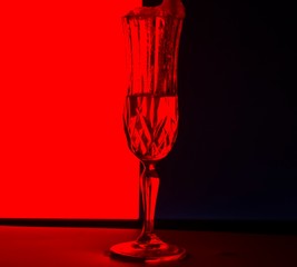 glass with foam on a red-black background.