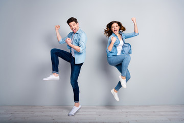 Full body photo of attractive lady handsome funny guy crazy fan jumping high up celebrating...